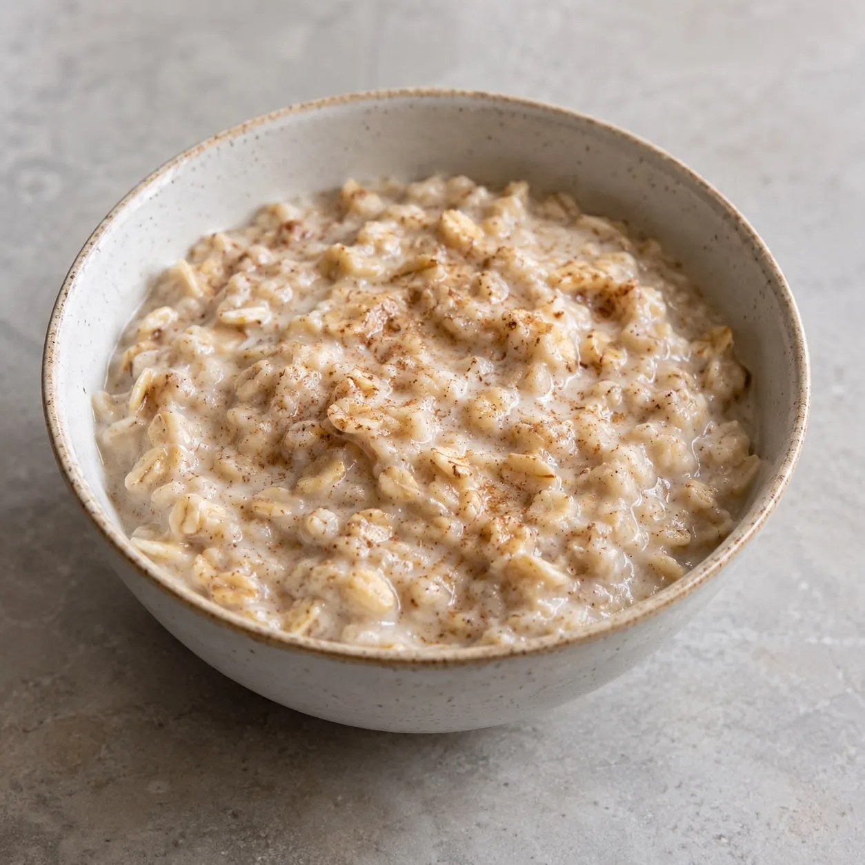 Oat porridge in a bowl, with a dusting of spice